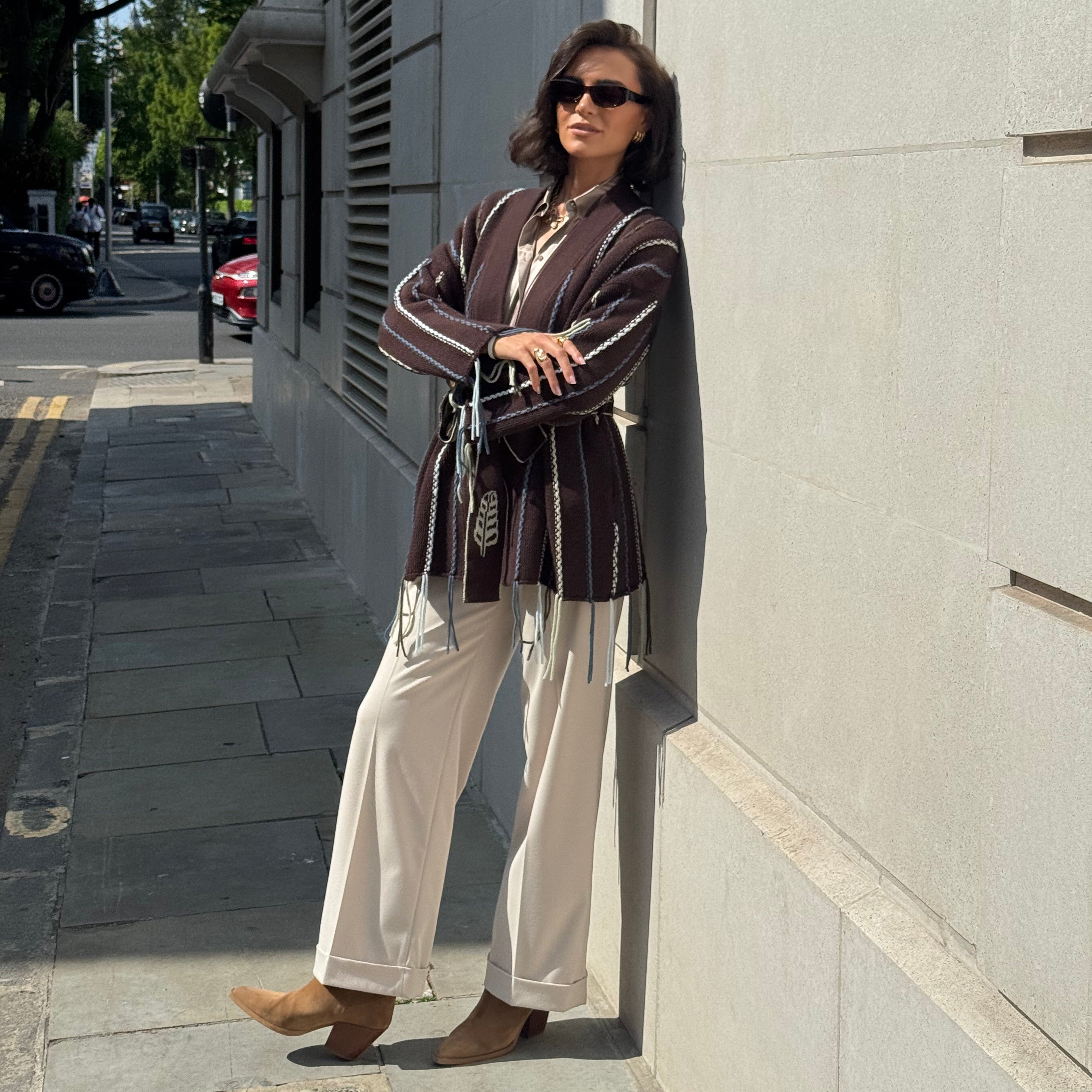 Woman walking on a sidewalk with a building in the background