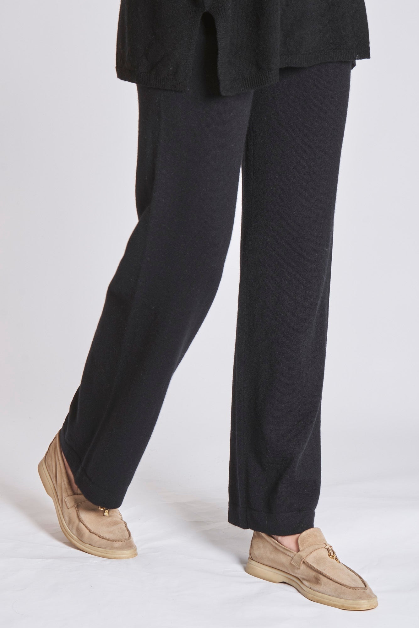 Black cashmere knit trousers from Divine Cashmere, full-length with visible knit texture and clean silhouette.