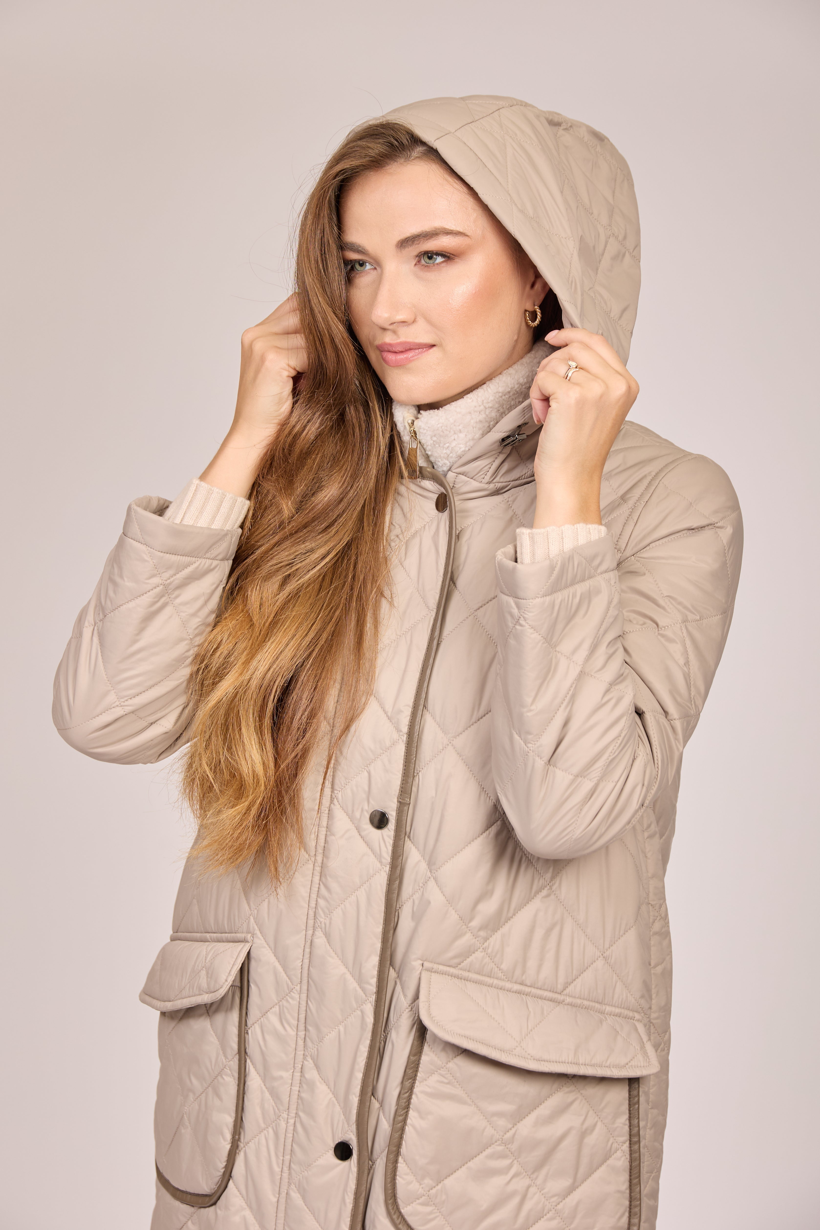Hooded quilted coat in taupe with visible quilted texture, hood and long sleeves