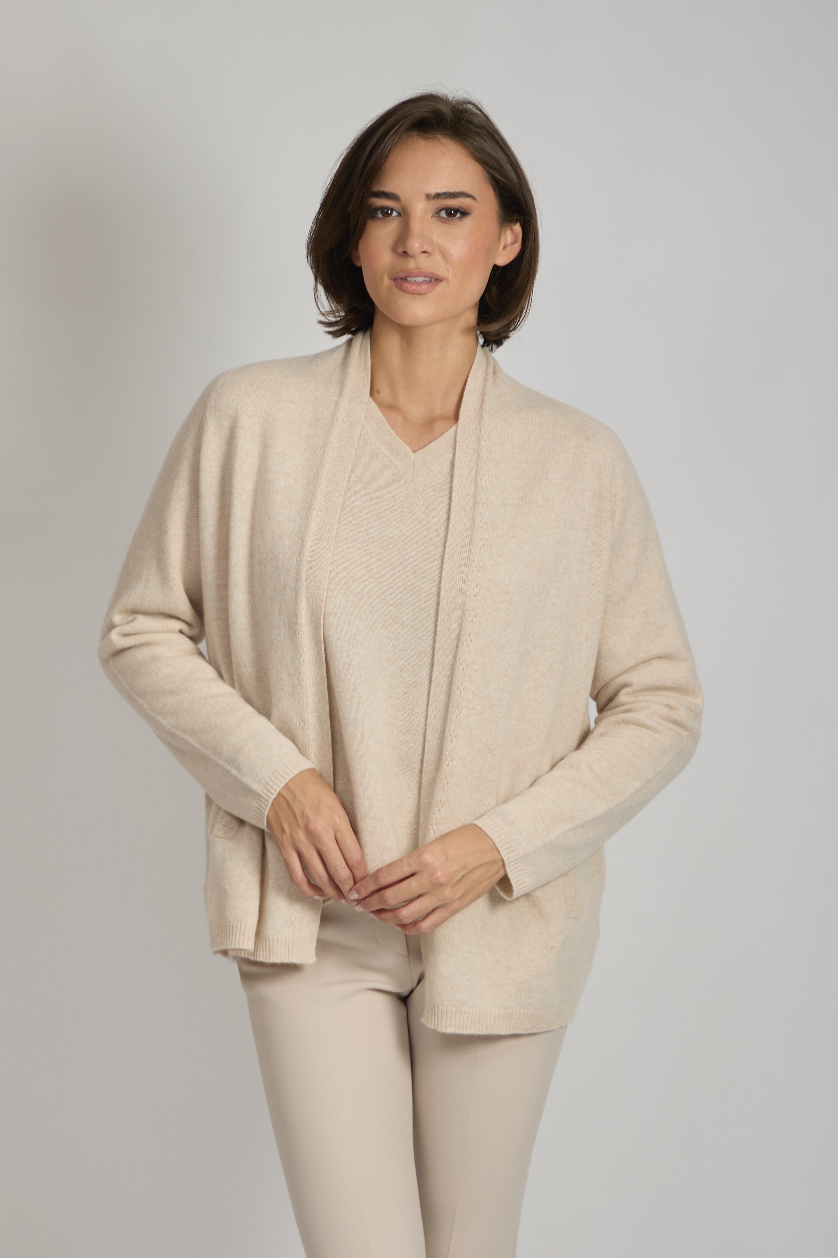 Long ribbed cashmere cardigan with knit texture and longline silhouette.