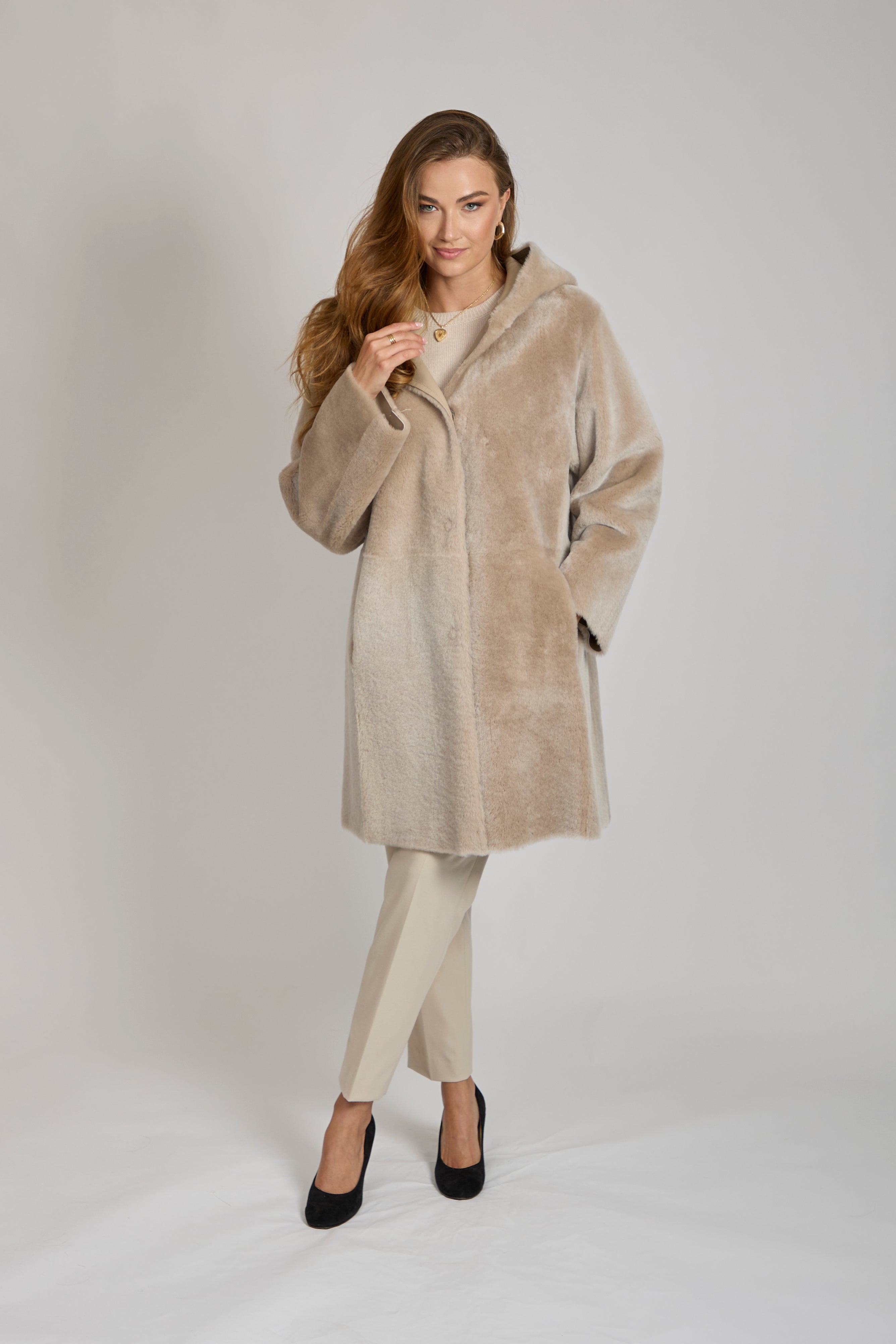 Reversible shearling coat by Divine Cashmere with plush texture and classic tailored silhouette.