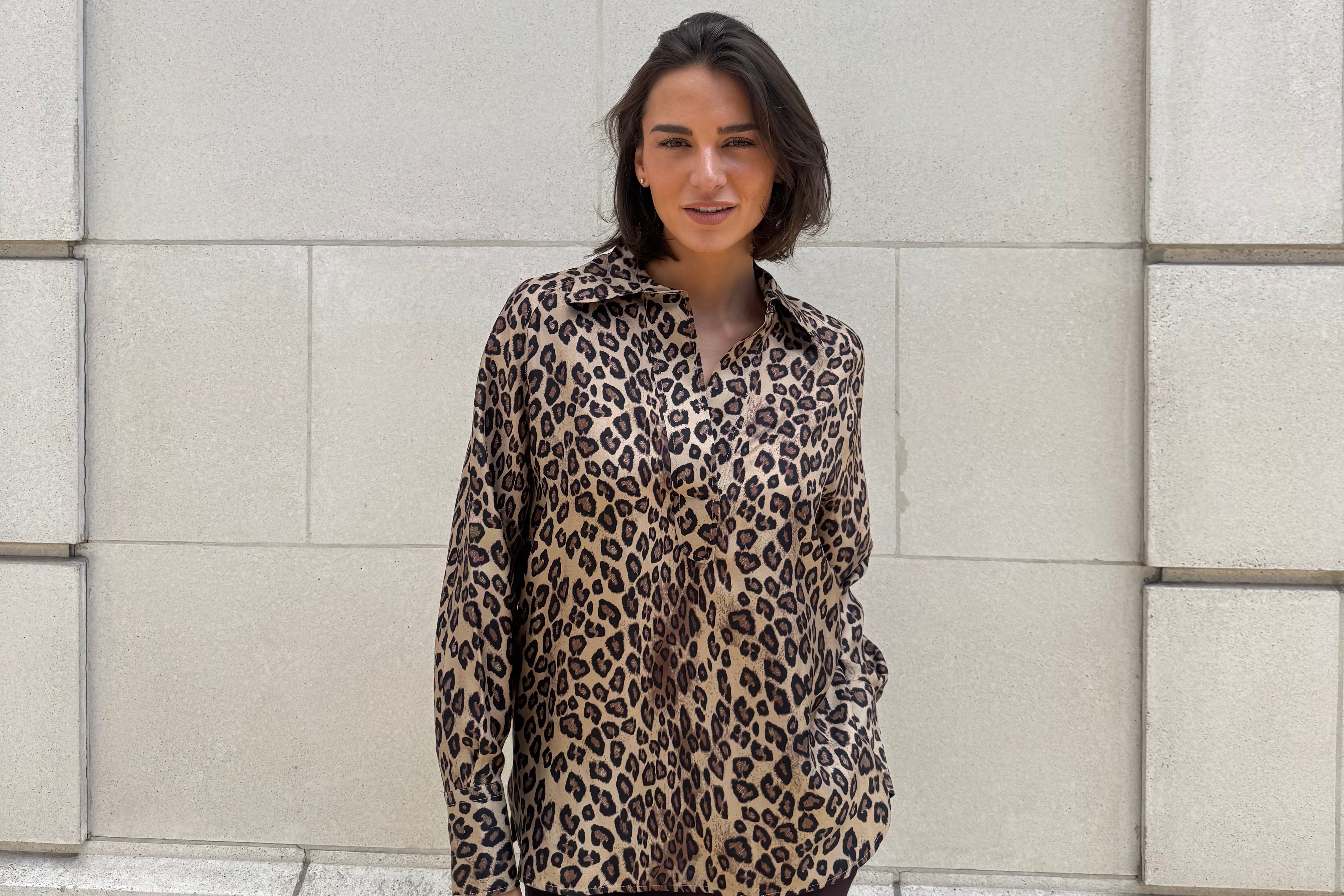 Divine Cashmere mannequin wearing a leopard print jacket standing on a tiled floor.