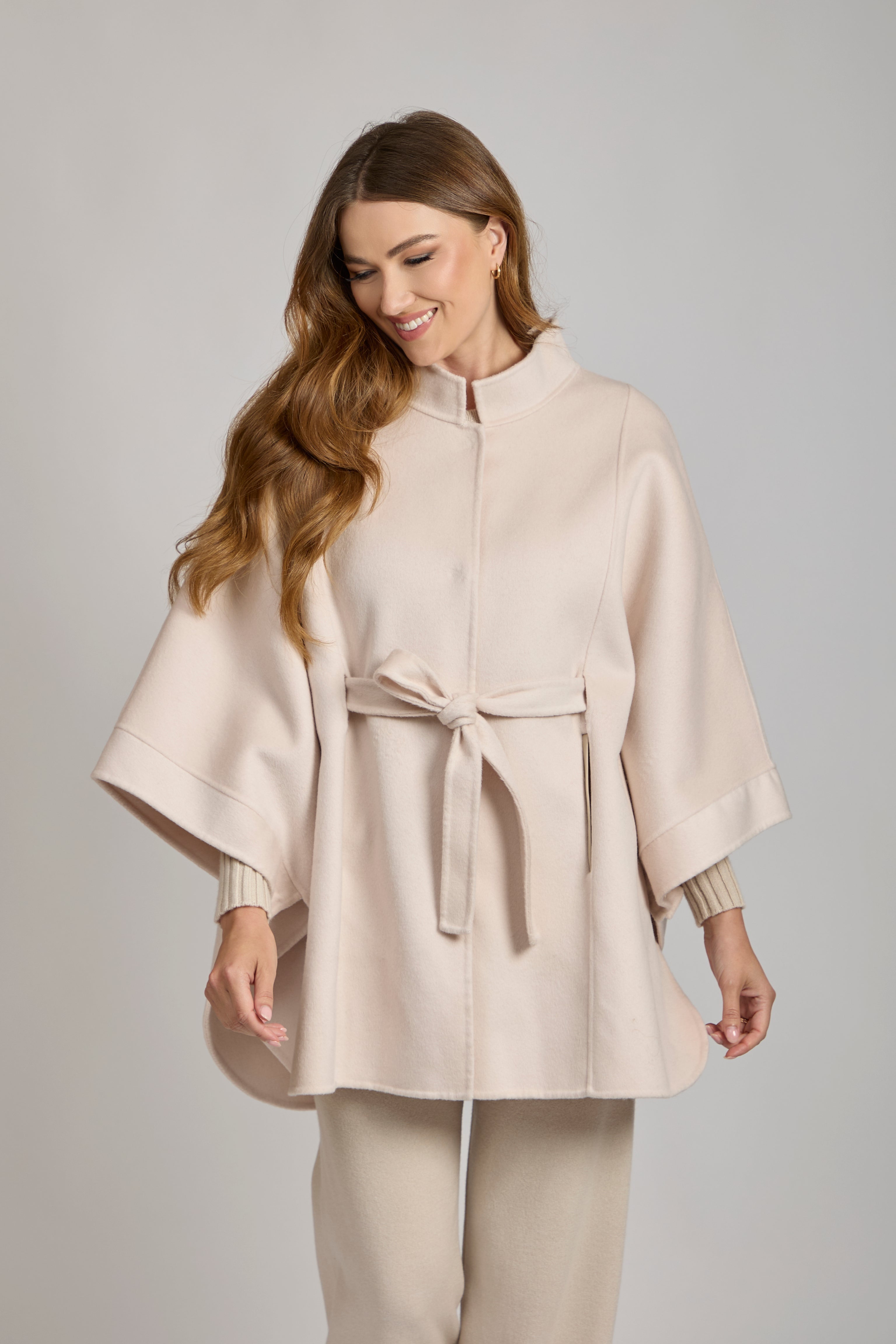 Ivory cashmere cape with draped silhouette and open front