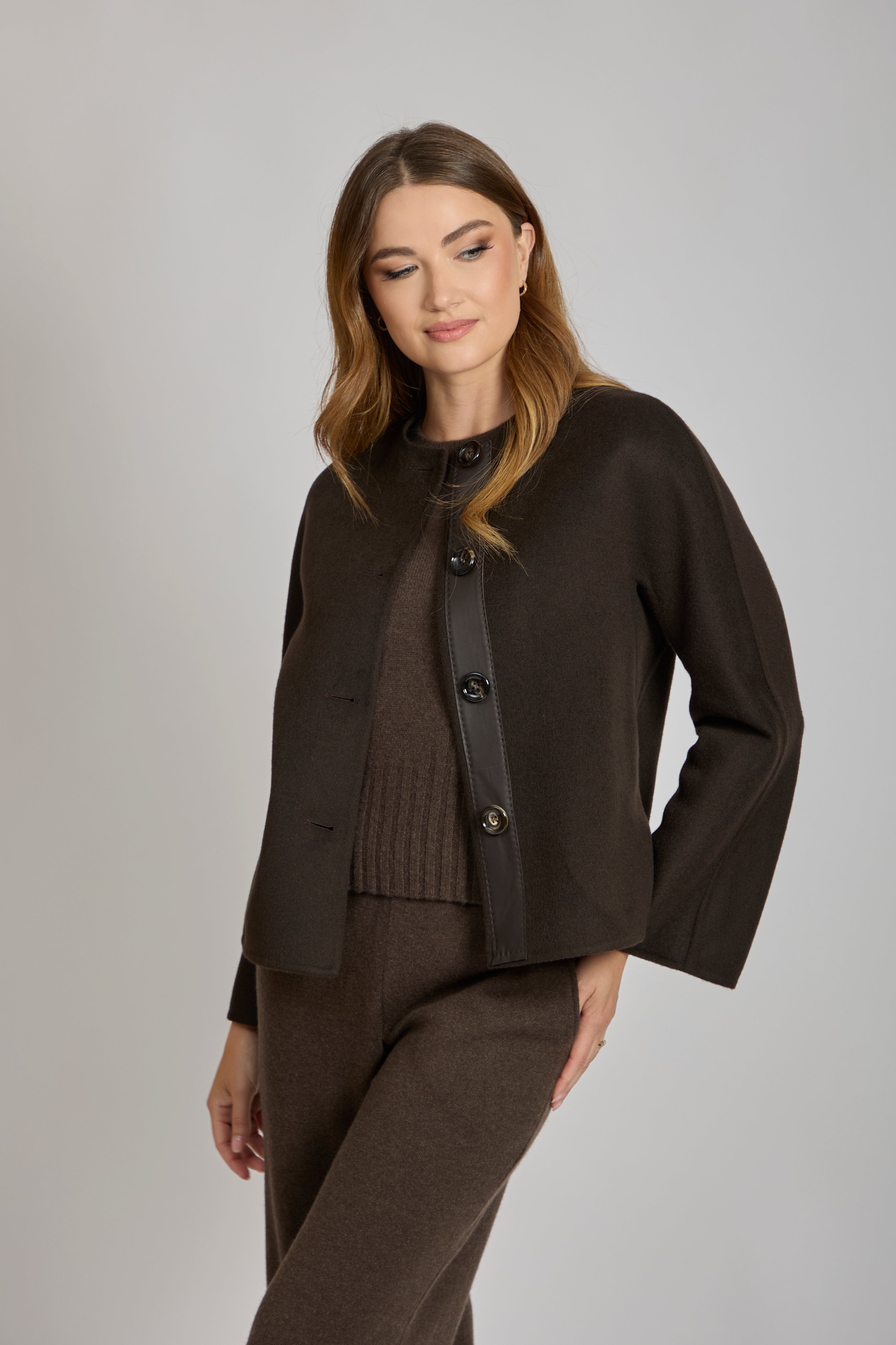 Cashmere short jacket with leather trim, cropped tailored silhouette and visible topstitching; Divine Cashmere label.