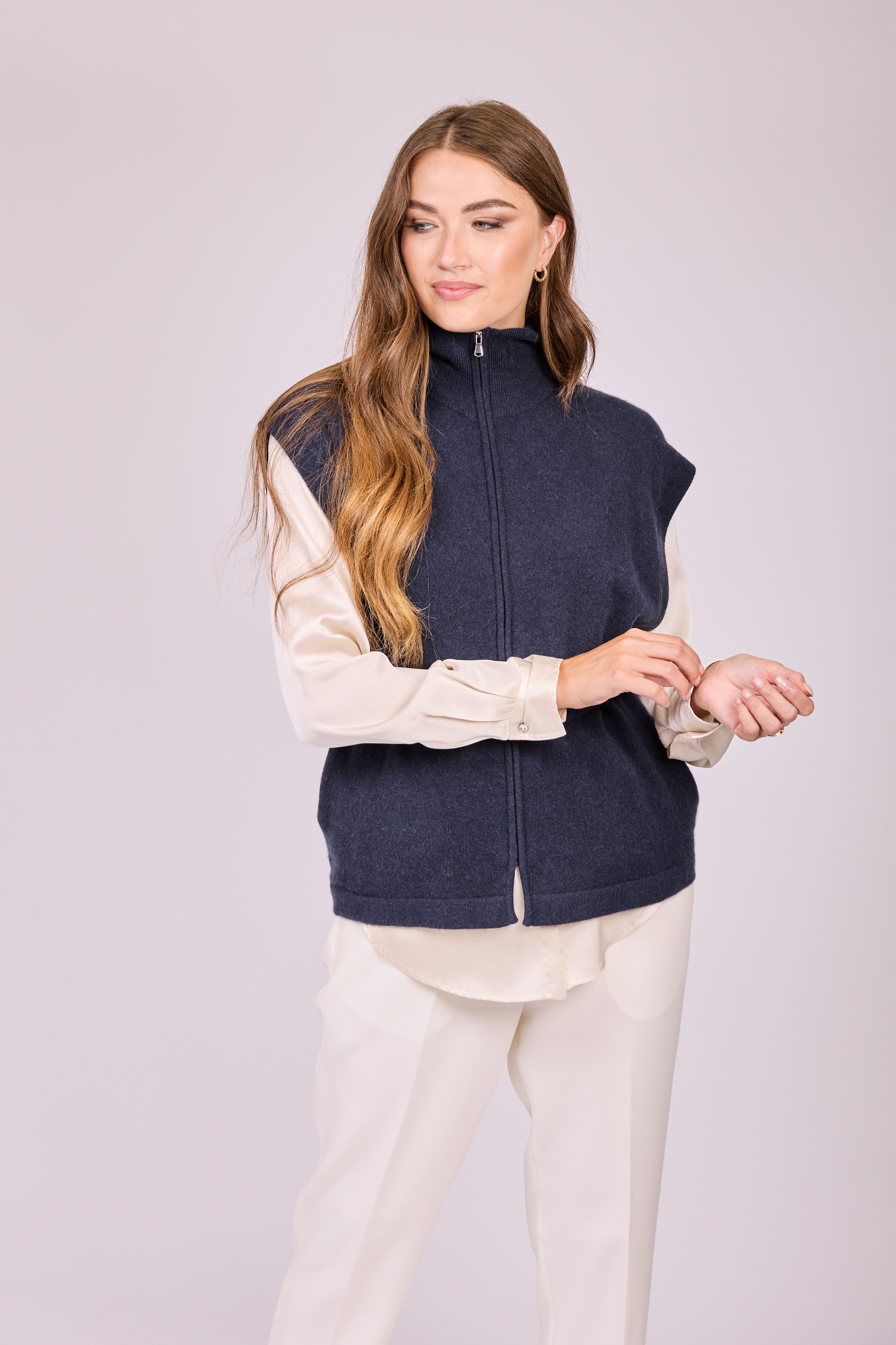 Navy cashmere zip vest with stand collar, sleeveless silhouette and ribbed hem