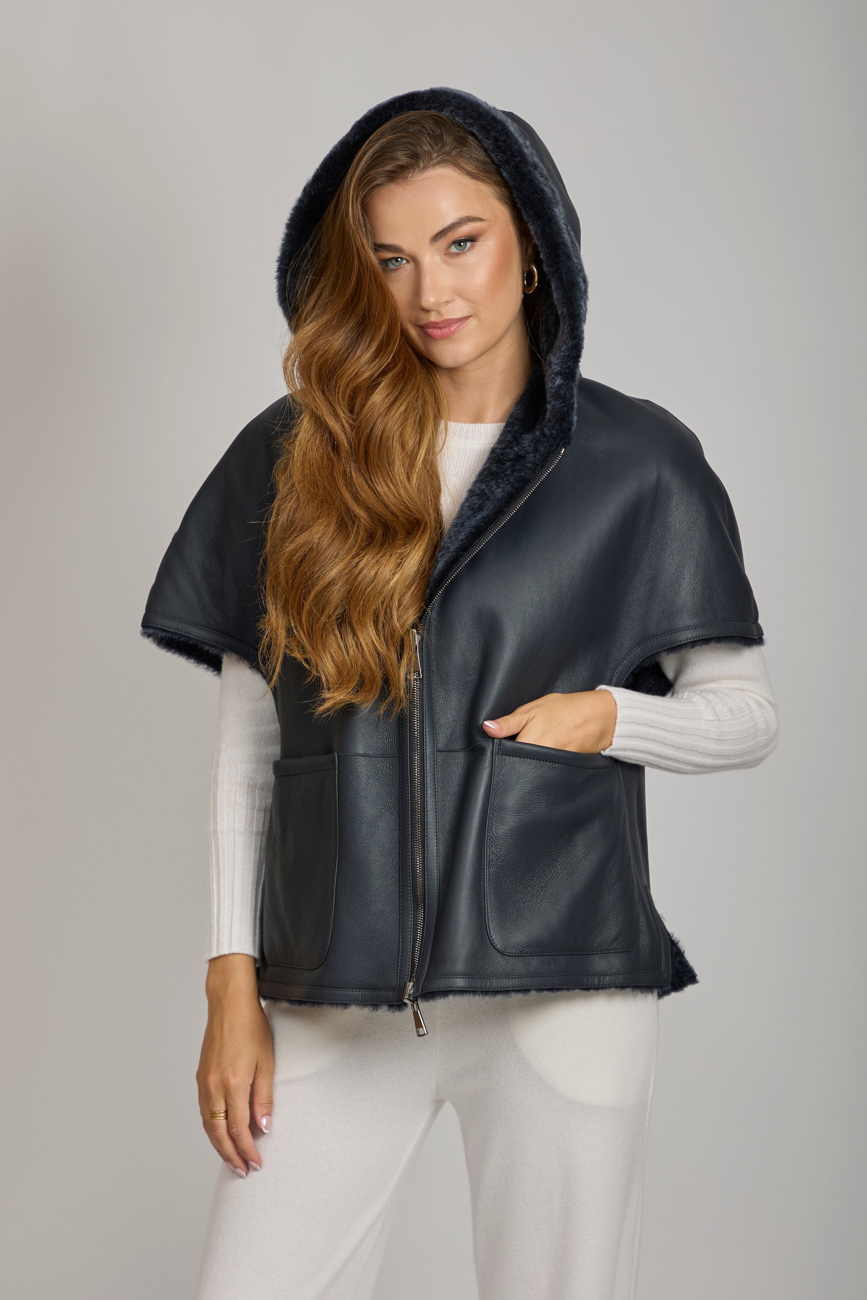 Divine Cashmere hooded shearling cape with plush texture and draped silhouette