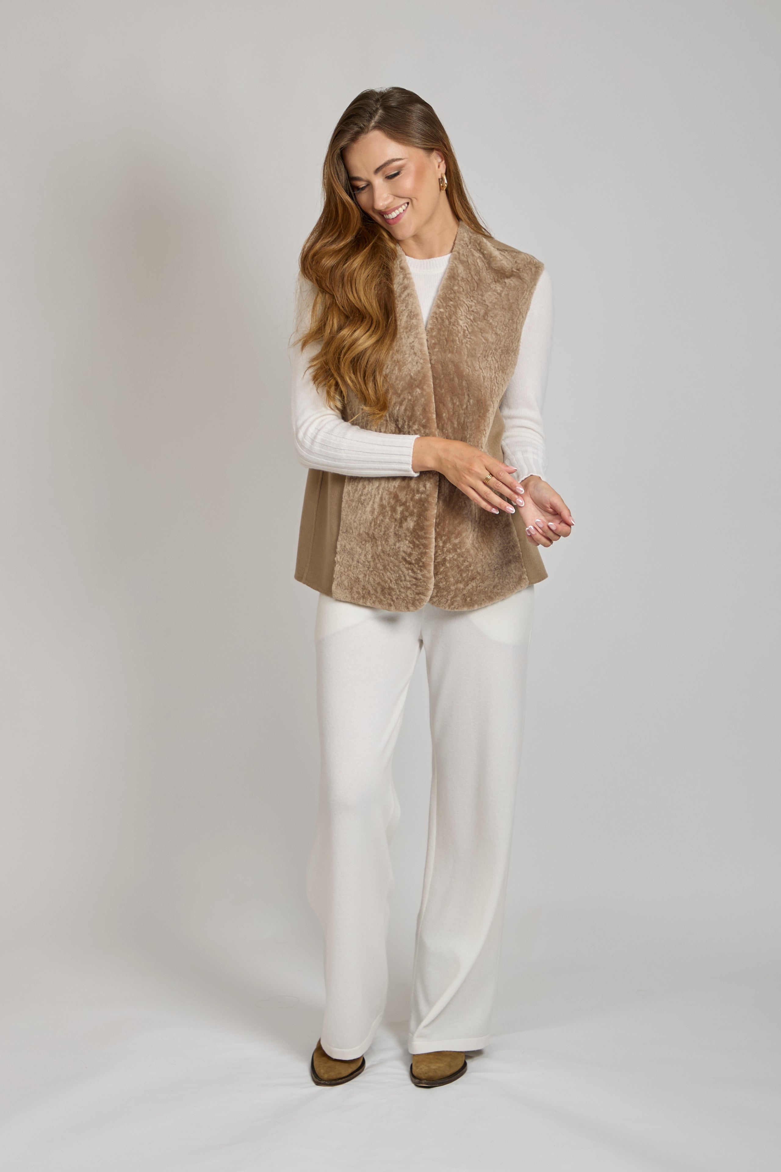 Divine Cashmere reversible cashmere shearling vest with plush lining and clean sleeveless silhouette.