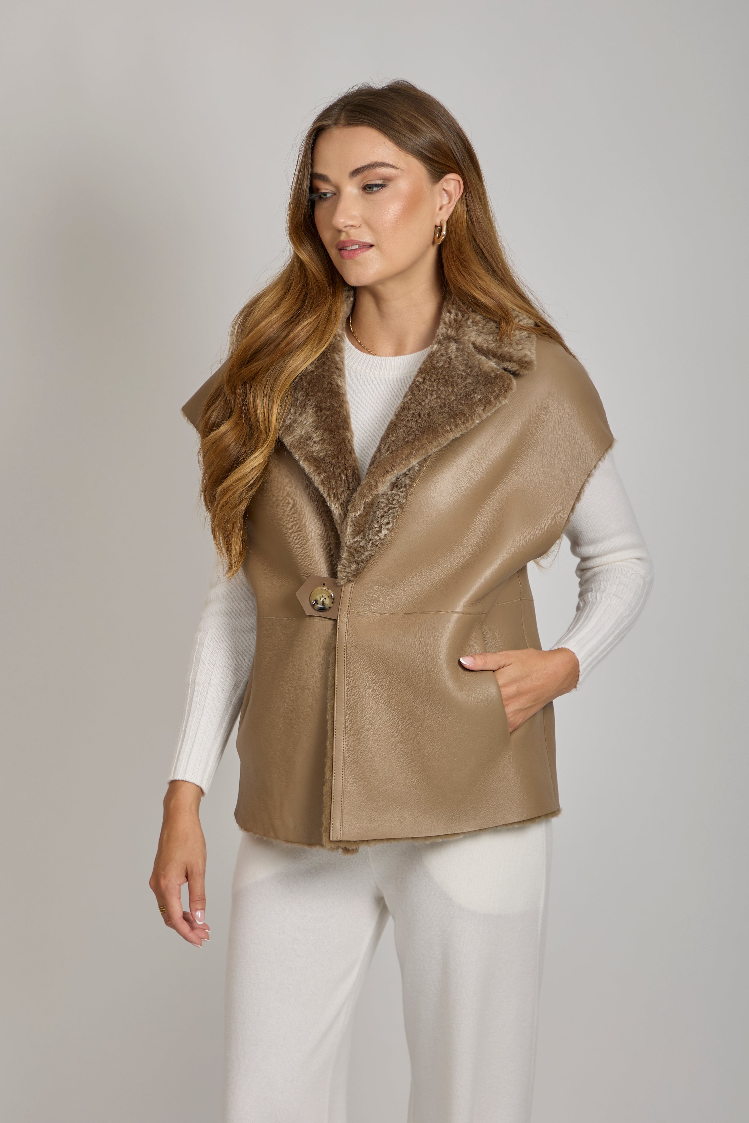 Reversible shearling cape in Caramel with plush texture and open-front silhouette
