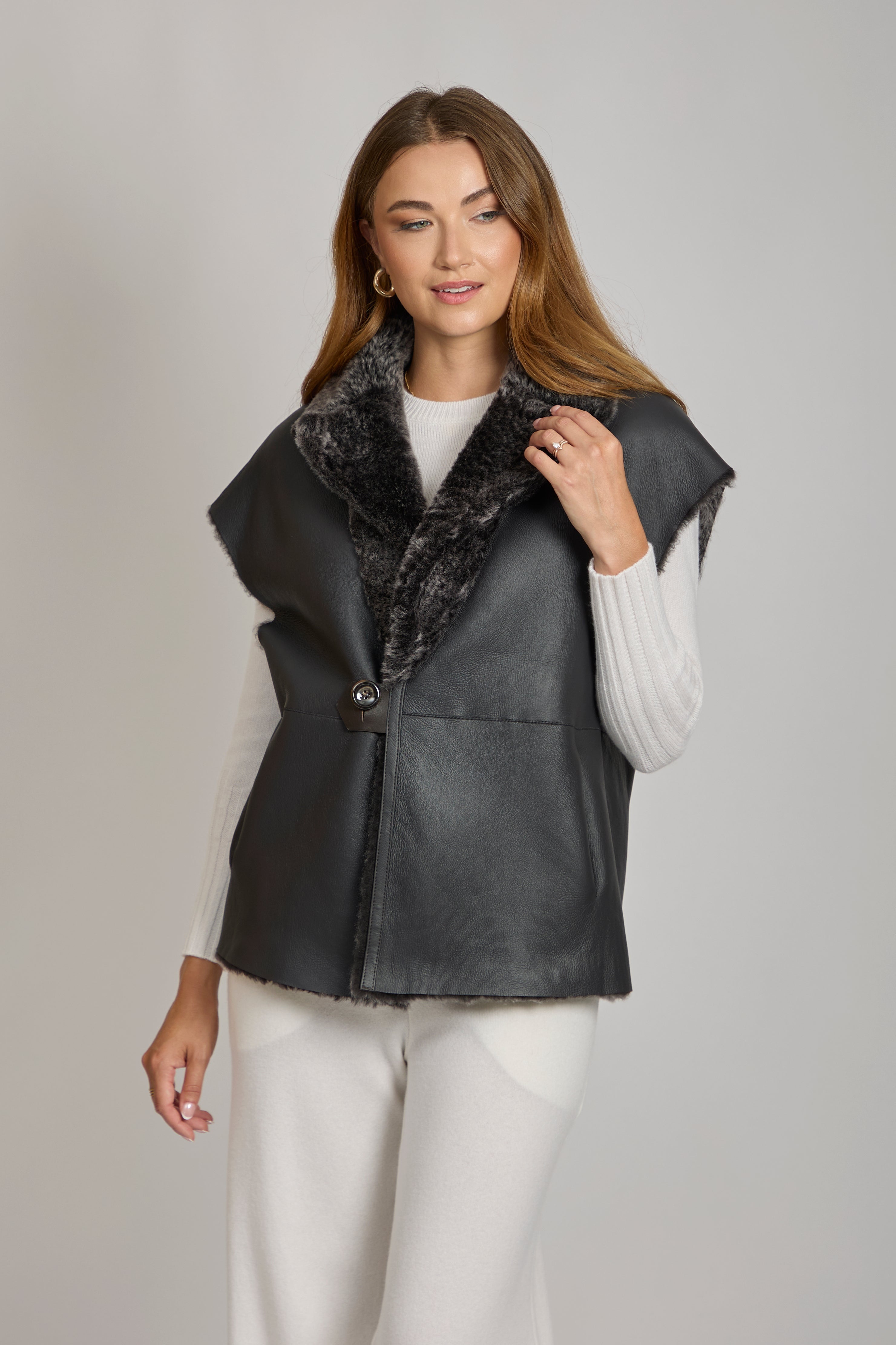 Reversible shearling cape with plush lining and clean open-front silhouette
