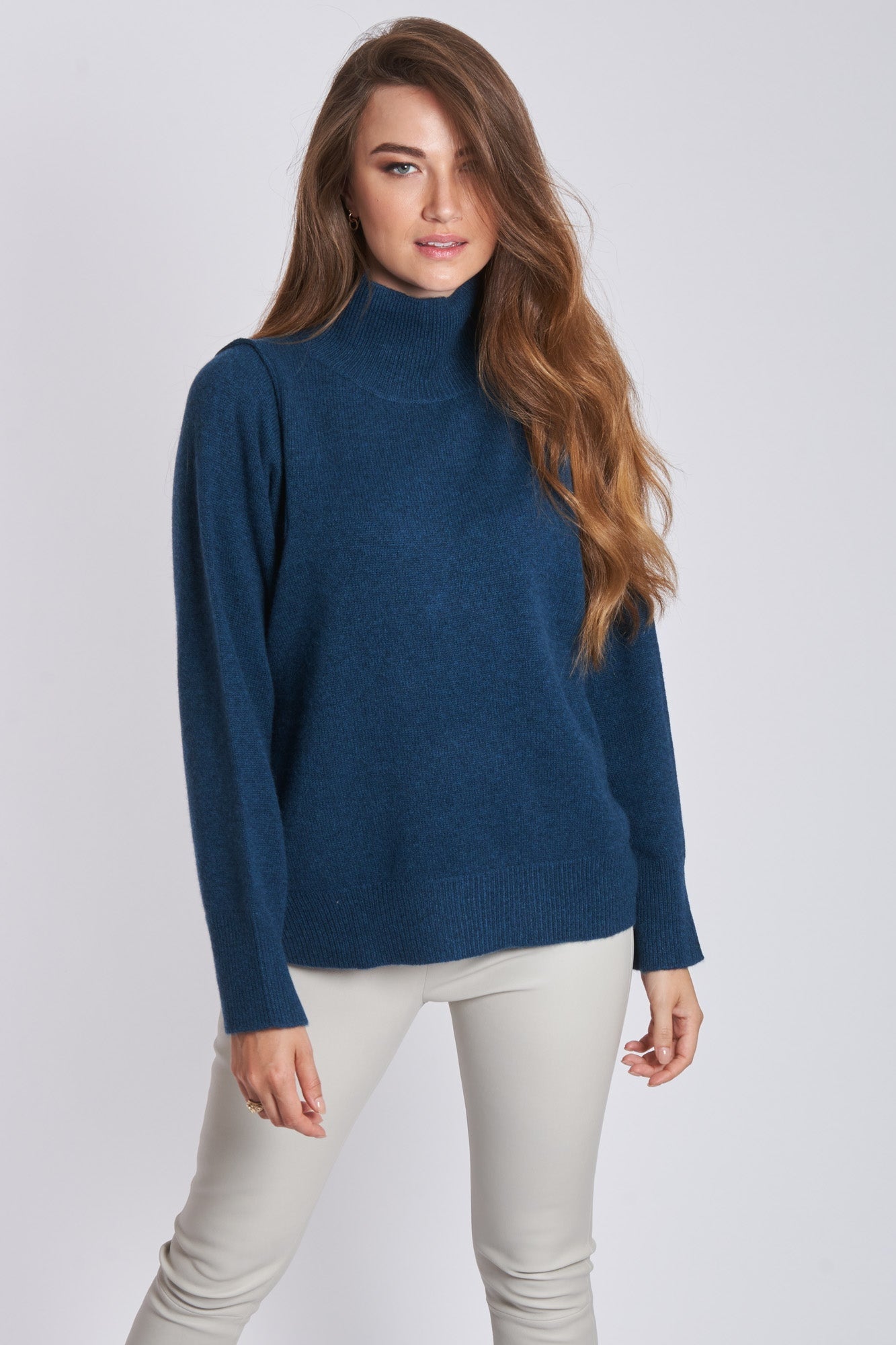 Ribbed cashmere high-neck jumper showing vertical rib texture and high neckline