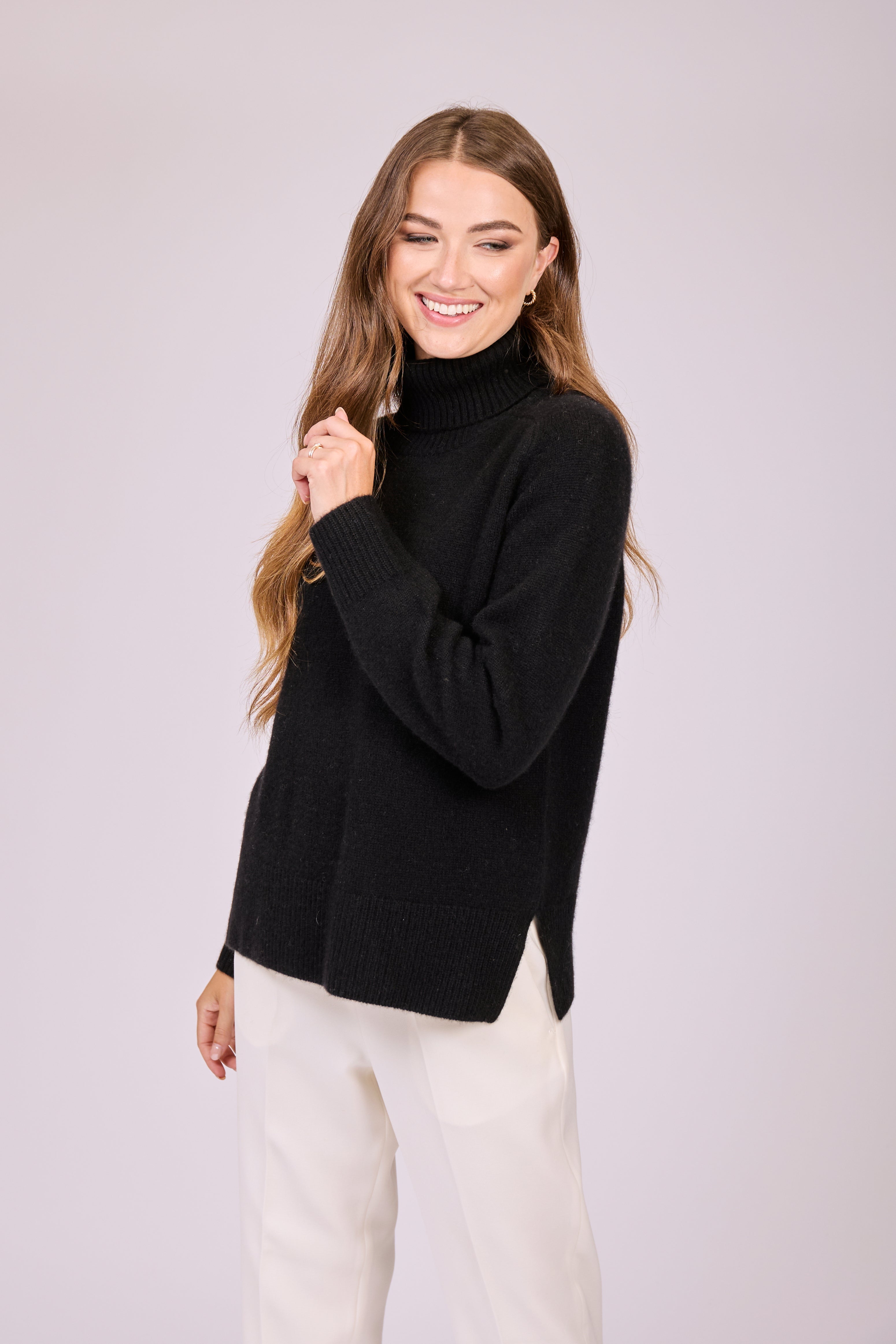 Thick cashmere turtleneck sweater with high collar and heavy knit texture.